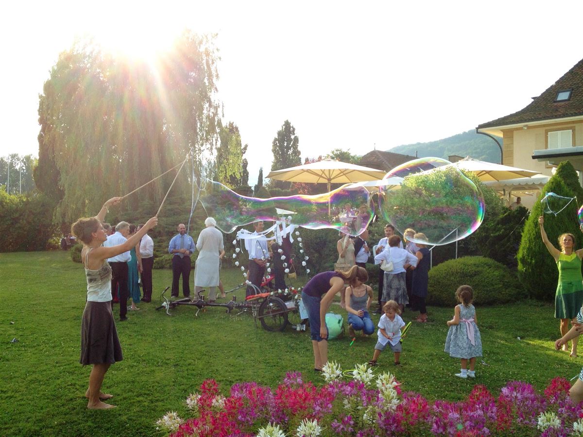 Riesenseifenblase wird bei einer Hochzeitsfeier im Garten vorgeführt